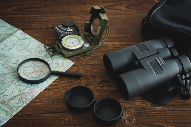 Orienteering map, binoculars and compass